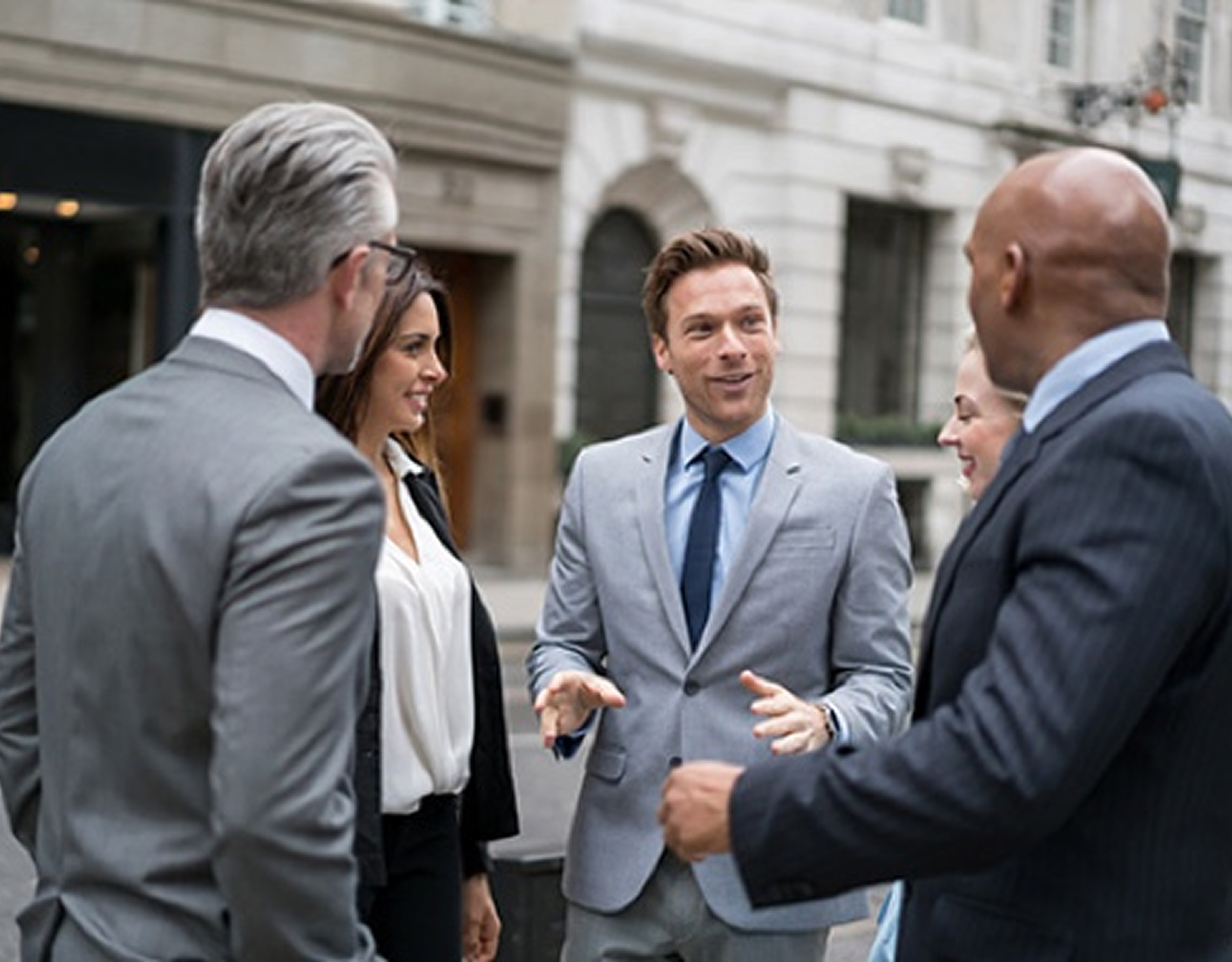 Business professionals having a conversation outside.