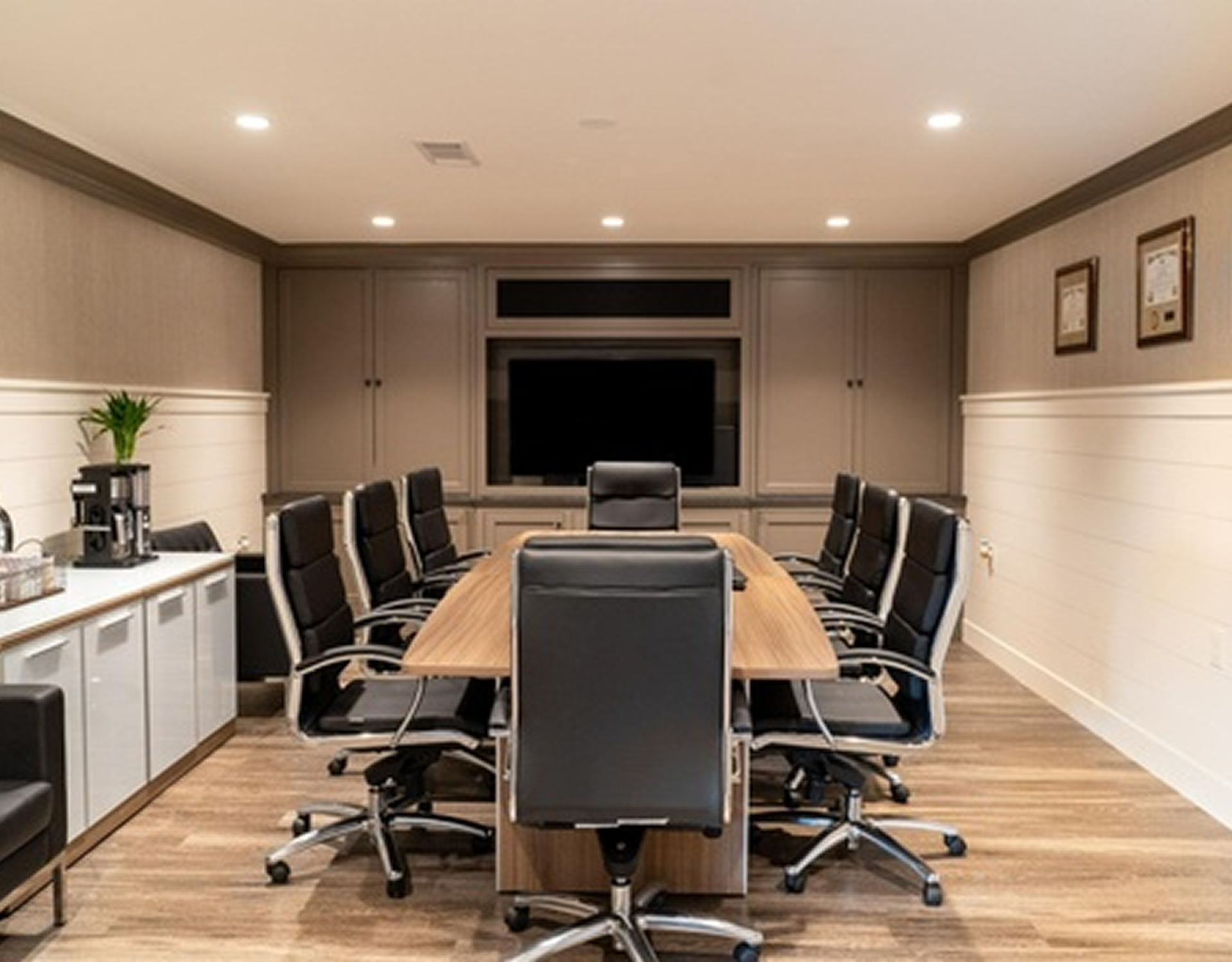 Modern conference room with black chairs.