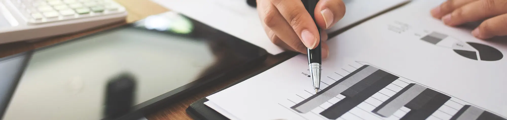 Person analyzing financial charts and graphs.