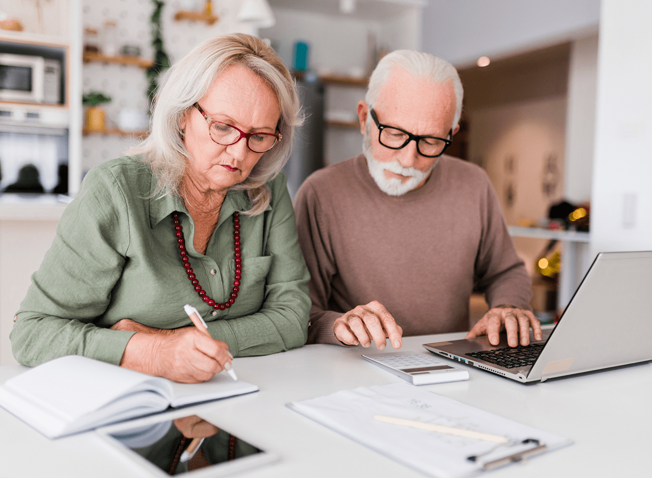 Elderly couple working on finances together