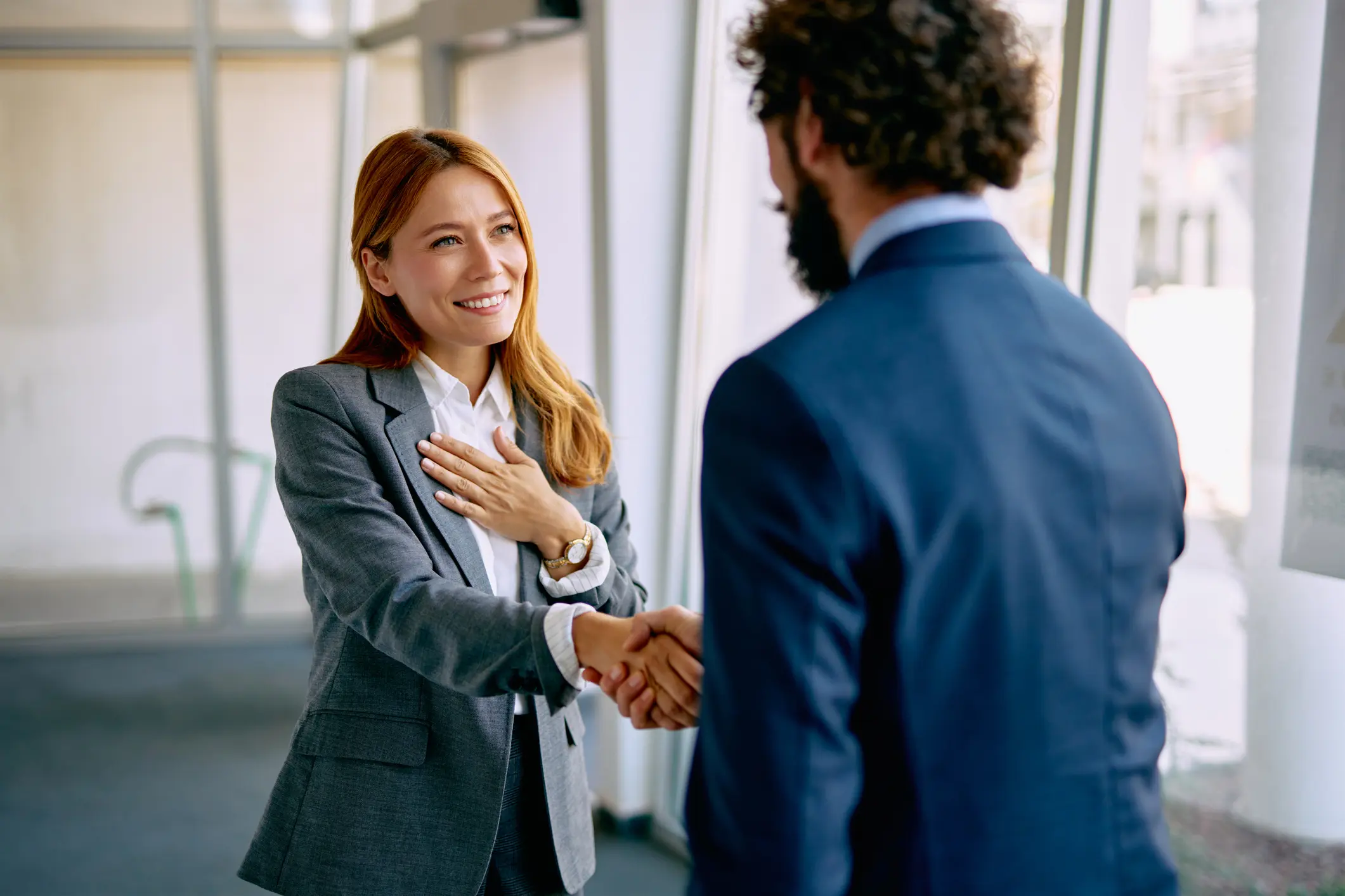 Smiling woman shaking hands with man
