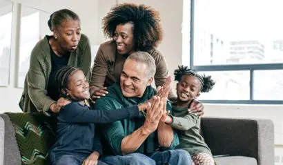 Grandfather and grandchildren having fun indoors