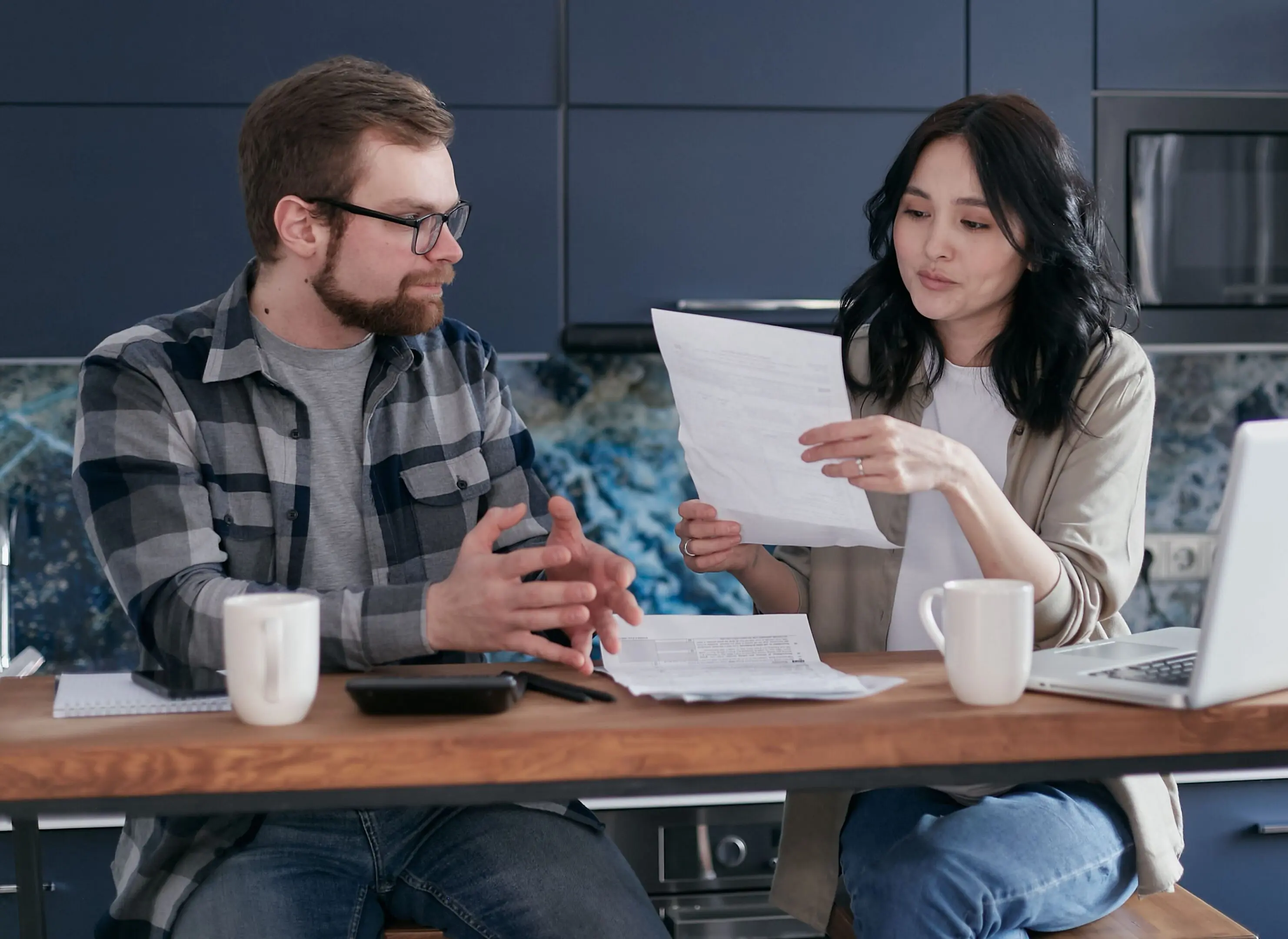 Man and woman discussing paperwork.