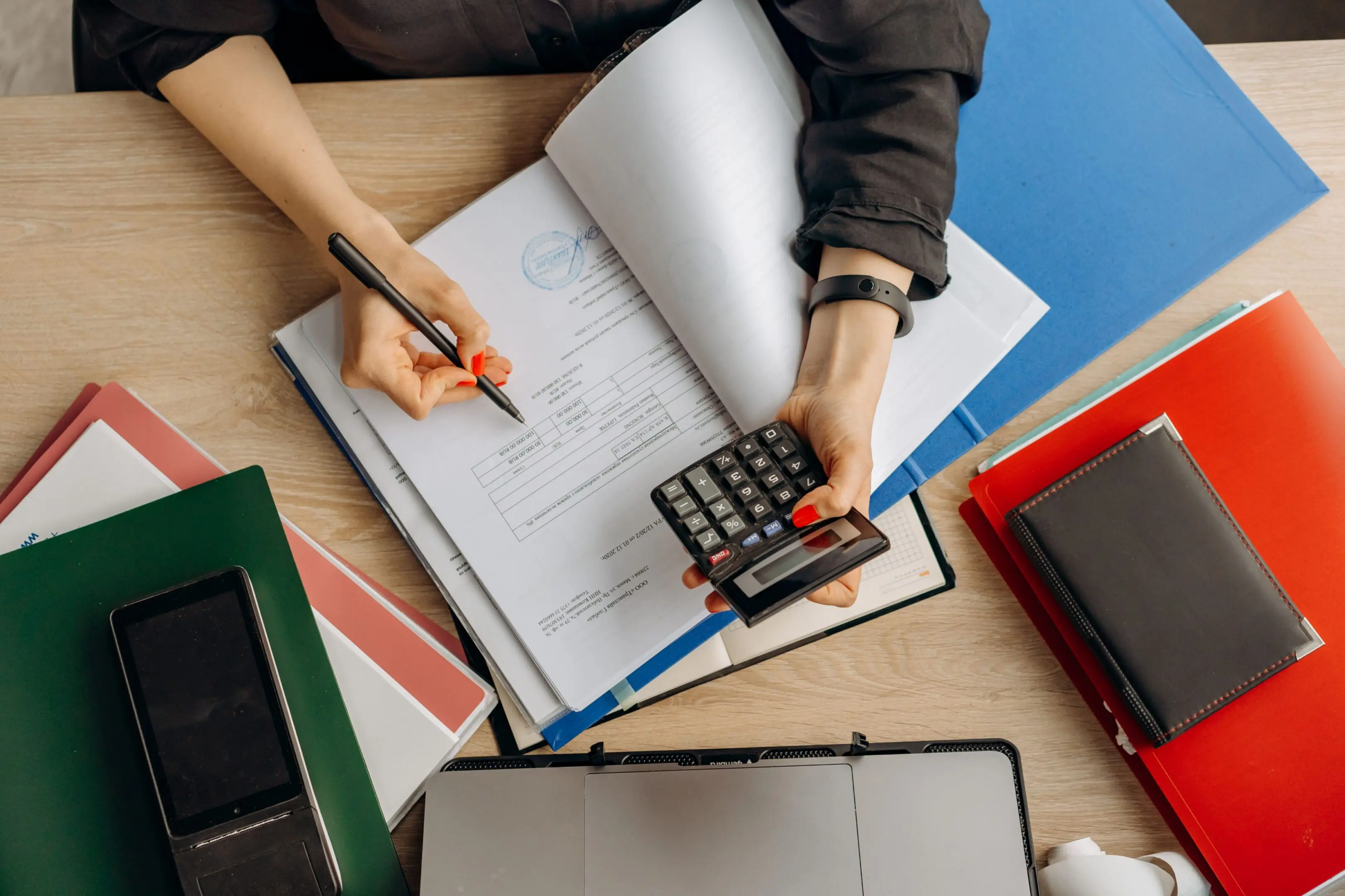 Office desk with files and calculator